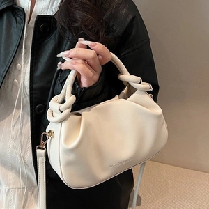Chic cream ruched cloud bucket bag with adjustable crossbody strap and top handle design
