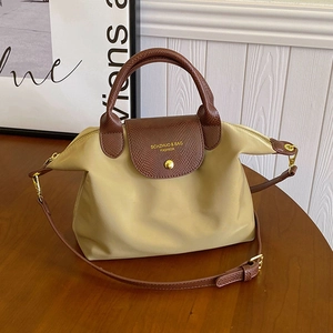 Minimalist khaki nylon dumpling tote bag with brown crocodile pattern leather handles