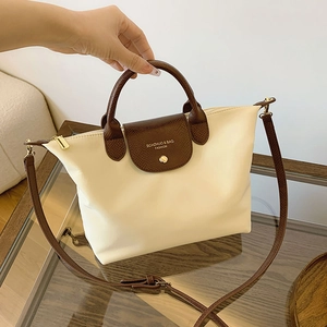 Chic cream oxford fabric tote bag with brown snakeskin pattern flap and shoulder strap