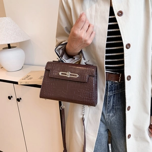 Elegant dark brown crocodile pattern handbag with silver hardware and top handle strap