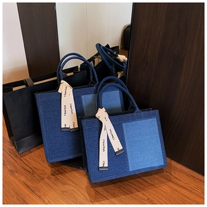 Detailed comparison of large and small patchwork denim tote bags with ribbon charms