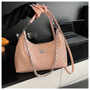 Detail of dusty pink pleated shoulder bag with silver metal lock and chain strap