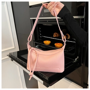 Detailed texture of pink pleated PU leather underarm bag with adjustable knot strap