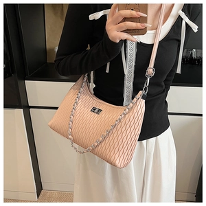 Detail of pink hobo bag with pleated texture, metal twist lock and dual shoulder straps