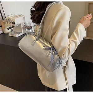 Silver metallic cracked leather shoulder bag with a checkered bow charm and dual handles