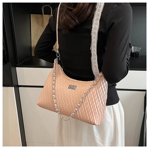 Detail of light pink pleated leather shoulder bag with silver chain and metal clasp