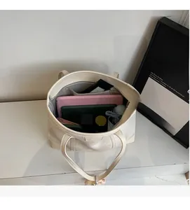 Top view of large tote bag interior showing spacious capacity for tablet and umbrella