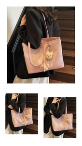 Detail of pink tote bag showing leather patchwork textures and cute bear charm accessory