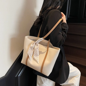 Minimalist beige leather tote bag with brown straps and checkered scarf for office
