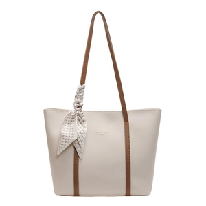 Minimalist beige leather tote bag with brown straps and silk scarf for women's daily commute