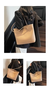 Detail of apricot tote bag featuring lychee grain leather and front snap button pocket