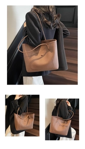 Close-up of brown litchi pattern leather tote bag with functional front snap pocket