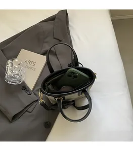 Spacious interior of canvas bucket bag with leather trim and smartphone pocket