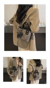 Detail of vintage grey marble pattern bucket bag with black strap and dog charm