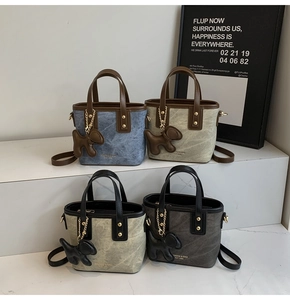 Detail of mini tote bags in four vintage colors with texture and cute dog charm
