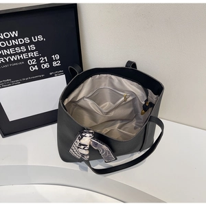 Interior view of black pebbled leather tote bag with silk scarf and zipper pocket