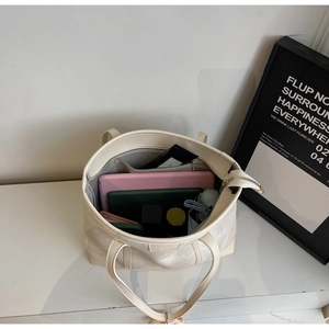 Top view of large white tote bag interior showing spacious compartments for daily items