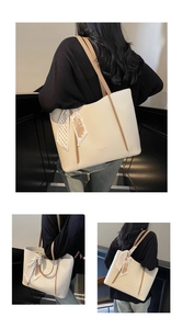 Detail view of large cream tote bag with litchi grain leather and silk scarf accessory