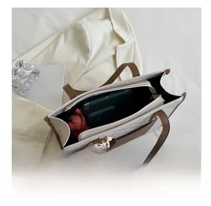 Spacious interior of beige checkerboard tote bag showing storage for daily essentials