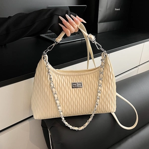 Minimalist beige pleated faux leather handbag with silver lock and metal chain strap
