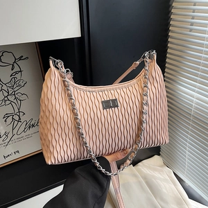 Chic pink pleated hobo bag with silver chain and leather strap shown in a modern hand-held pose