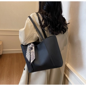 Black litchi grain tote bag with decorative geometric floral silk scarf on side