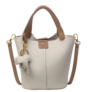 Litchi pattern bucket bag with caramel straps and elephant charm in beige leather
