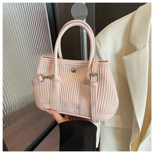 Detail of light pink pleated bucket bag with silver metal buckle and soft PU texture