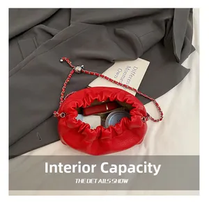 Internal view of red ruched crossbody bag showing capacity for lipstick and makeup items