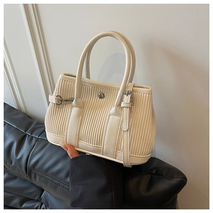 Detail of off-white pleated bucket bag showing vertical texture and silver hardware