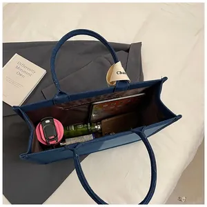 Macro view of large capacity canvas tote bag interior with multiple storage pockets