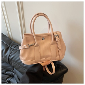 Detail of pink pleated bucket bag with vertical stitching and round silver metal clasp