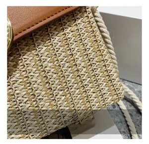 Macro detail of straw weaving texture with brown leather trim and rope strap