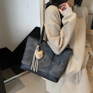 Large marble pattern tote bag with teddy bear charm and black leather straps