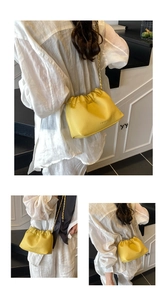 Detailed view of yellow lychee texture pleated cloud bag with metallic chain strap