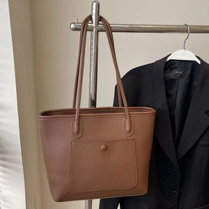 Minimalist large capacity dark brown leather tote bag for women showing a professional look