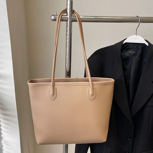Large beige pebbled leather tote bag with thin double straps for women's daily commute