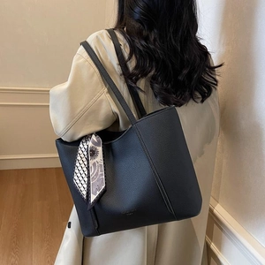 Minimalist black pebble leather tote bag with decorative patterned scarf for women