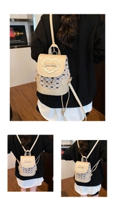 Close-up of beige bow backpack with heart lace trim and adjustable multi-way straps