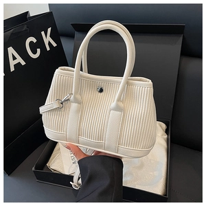 Pleated off-white bucket bag with silver hardware shown in high-end gift packaging