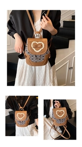 Detail of vintage brown PU leather backpack with lace trim and bow patterns