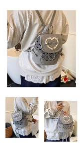 Detail showing grey faux leather mini backpack with houndstooth fabric and bow