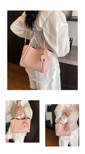 Detail of pink lychee leather bucket bag with cute elephant charm and versatile strap