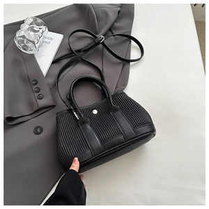 Detail of black pleated bucket bag with lychee grain leather and silver hardware