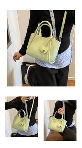 Detail of light green litchi grain bucket bag with elephant charm and adjustable strap
