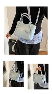 Macro view of light blue lychee pattern leather bucket bag with cute elephant charm