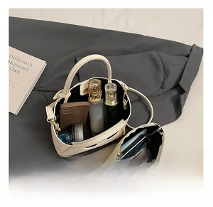 Spacious interior of beige leather tote bag with small pouch showing daily essentials