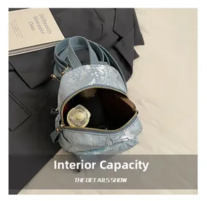 Detailed interior view of light blue jacquard backpack with floral patterns and daily items
