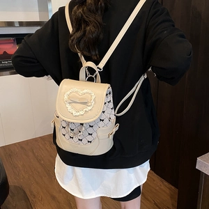 Zaino beige chic con pizzo e motivo a quadri indossato sulla schiena della modella