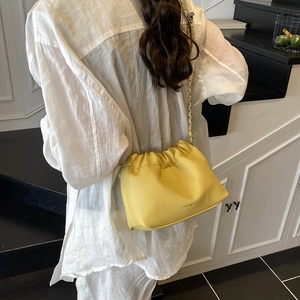 Bright yellow lychee textured pleated crossbody bag with silver chain strap for women